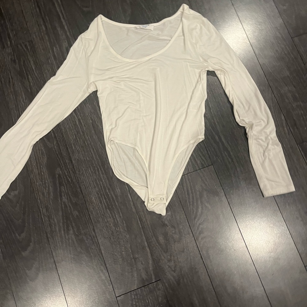 White long-sleeve scoop neck bodysuit.